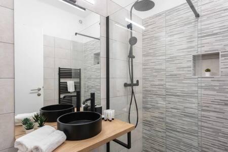 a bathroom with two sinks and a shower at Lux Nest I City Apartment URBAN STAY in Zagreb