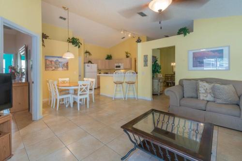 a living room with a couch and a table at 4br/3ba Disney Area Luxury Resort with pool/spa in Orlando