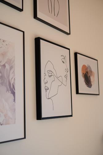 a row of framed pictures on a wall at Neu! Auszeit in der Bergen in Wertach
