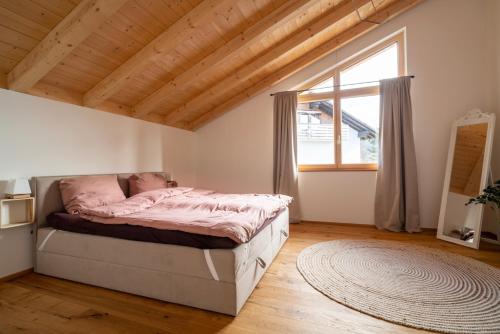 a bedroom with a bed and a large window at Neu! Auszeit in der Bergen in Wertach