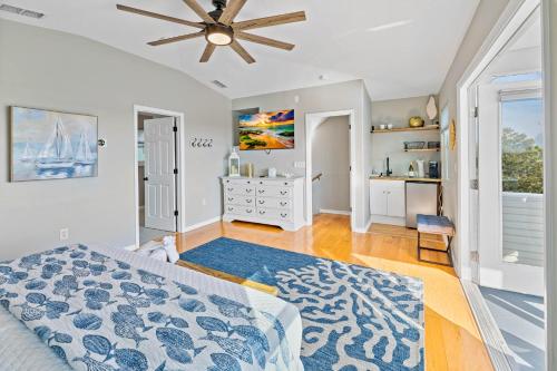 a bedroom with a bed and a ceiling fan at 5 Bed3bath waterfront pool home with full gym, office, and heated pool! in Hernando Beach
