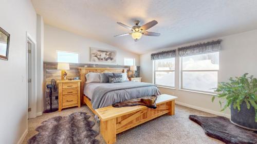 a bedroom with a bed and a ceiling fan at New! Grand Manor - Close to Tamarack and Lake Cascade - Pet friendly - fenced yard - trailer parking in Donnelly