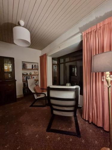 a living room with a chair and a lamp at The Lodge at Heathfield House in Ballycastle
