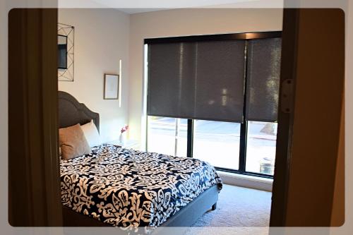 a bedroom with a bed and a large window at Atlanta at The Interlock Lux Escape in Atlanta