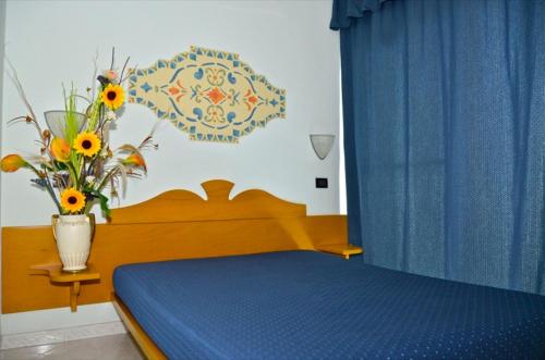 Säng eller sängar i ett rum på Resort Alessidamo Club Metaponto