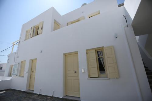 a row of doors and windows on a white building at The White Suites in Adamas