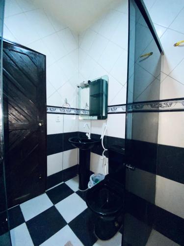 y baño con aseo, lavabo y espejo. en Quarto disponível, en Juazeiro do Norte