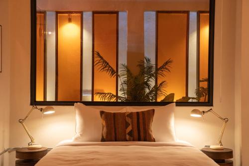 a bedroom with a large mirror above a bed at NOA by DW in San Juan