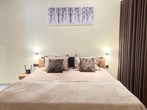 a bedroom with a large bed with two pillows at New Haven Polonnaruwa in Polonnaruwa