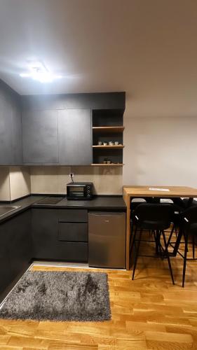 兹拉蒂博尔Silver Wolf SPA & relax的厨房配有桌子和带地毯的台面