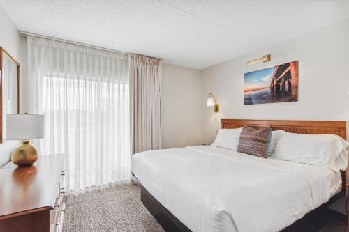 a hotel room with a bed and a window at Cape Suites Room 4 - Free Parking! Hotel Room in Rehoboth Beach