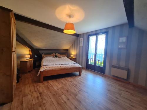 ein Schlafzimmer mit einem Bett und einem großen Fenster in der Unterkunft Guestroom Anould, 2 pièces, 4 personnes - FR-1-589-492 in Anould