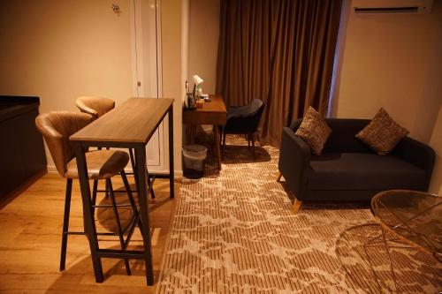 a living room with a table and a couch at Dê MOCCIS Boutique Hotel in Kuala Lumpur