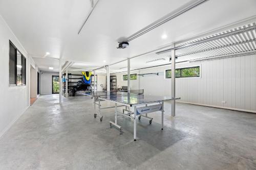 an empty room with a ping pong table in it at 11 Warbler Crescent in Kianga