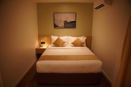 a bedroom with a bed and a picture on the wall at Dê MOCCIS Boutique Hotel in Kuala Lumpur