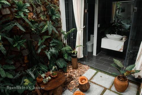 a bathroom with a toilet and some plants in it at ngaunhien's house - Homestay in Thôn Dư Khánh