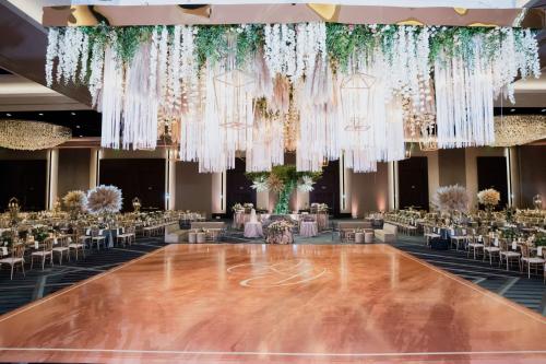 a dance floor in a ballroom with tables and chairs at Marriott Marquis Houston in Houston