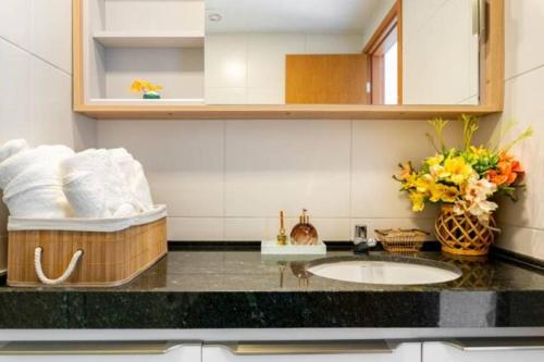 a bathroom with a sink and a counter top at Mana Beach Resort Muro Alto - vista piscina fantastico -e Makia beach in Porto De Galinhas