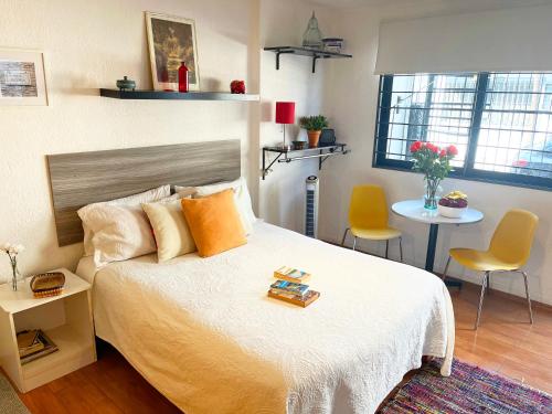 a bedroom with a bed and a table and chairs at Beguest Centro Concerts & Events in Mexico City