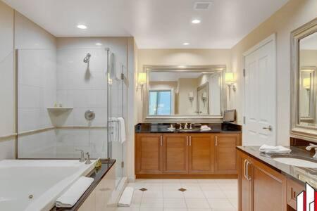 a bathroom with a tub and a shower and a sink at MGM Signature-07-802 1Br 2Ba Balcony Suite in Las Vegas