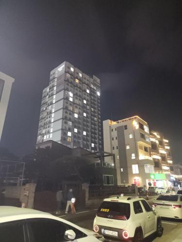 a white car parked in front of a tall building at Sokcho Summitbay 1807 "Ocean View" in Sokcho