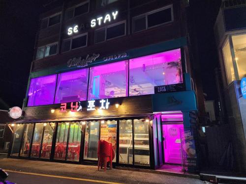 a store with purple lights on the front of it at Sokcho Summitbay 1807 "Ocean View" in Sokcho