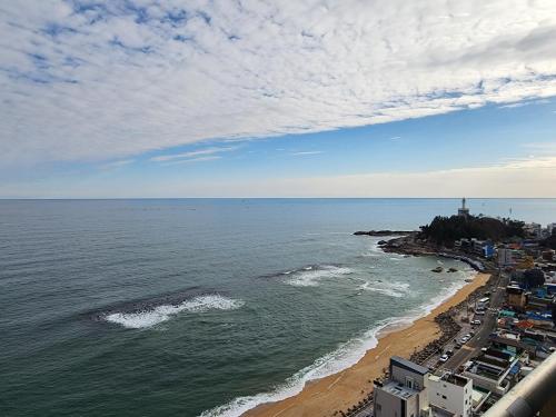 an aerial view of a beach with a lighthouse at Sokcho Summitbay 1807 "Ocean View" in Sokcho