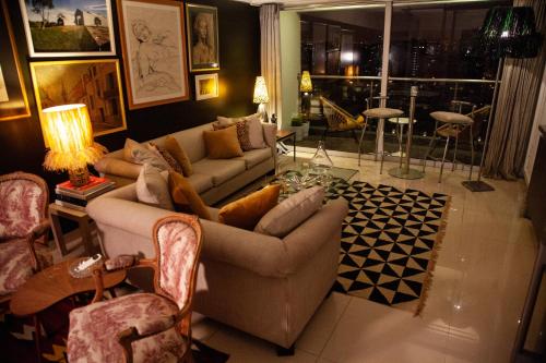 a living room with two couches and a table at Chic Miraflores AC HEATER 16th floor in Lima
