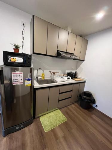 a small kitchen with a sink and a refrigerator at CASA JBL Megatower 4 in Baguio