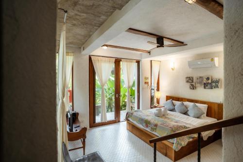 a bedroom with a bed and a large window at Proud Phu Fah Maerim Resort in Mae Rim