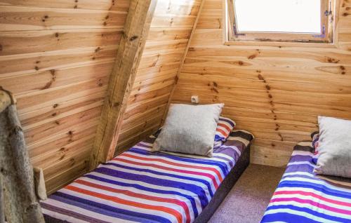 a room with two beds in a log cabin at 1 Bedroom Lovely Home In Mielno in Mielno