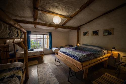 a bedroom with two bunk beds and a window at Pilliga Pottery Creative Farmstay in Coonabarabran