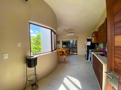 a kitchen with a large window and a table at Los Gallos - Suite superior in Lo de Marcos