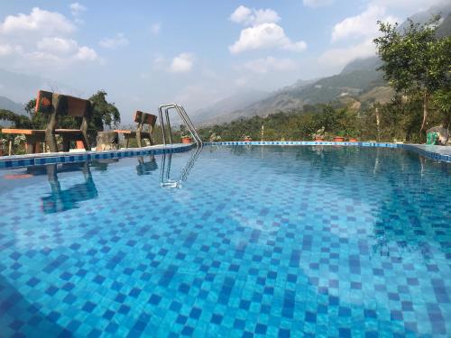 a swimming pool with a slide in the middle of it at Sau Meo Mountain View in Sa Pa