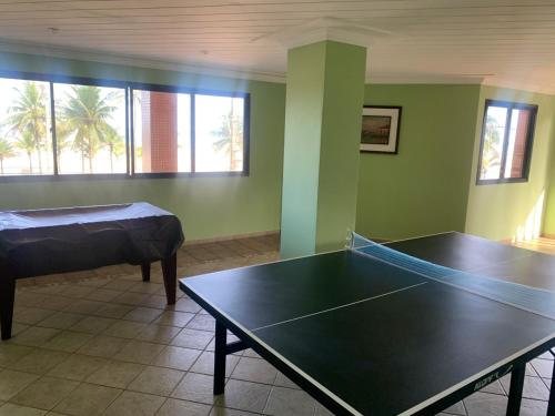 a room with a ping pong table in it at Apto frente à praia - Guilhermina in Praia Grande