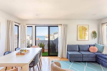 a living room with a blue couch and a table at Ocean View 1 BR Dream Escape in Manhattan Beach in Manhattan Beach