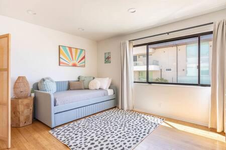 a living room with a couch and a window at Ocean View 1 BR Dream Escape in Manhattan Beach in Manhattan Beach
