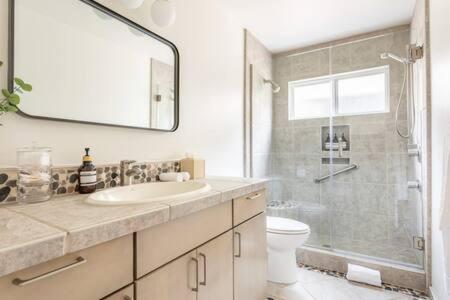 a bathroom with a sink and a shower and a toilet at Relax and Unwind Luxe Home Blocks from Beach in Hermosa Beach