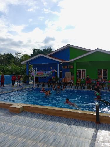 un grupo de personas nadando en una piscina en Maksu homestay en Kuala Nerang