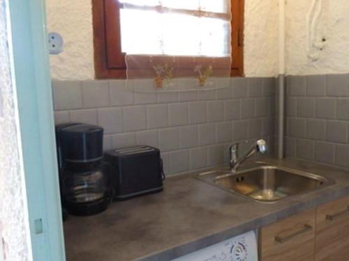 Il comprend une cuisine équipée d'un évier et d'une cafetière. dans l'établissement Charmant T2 rénové, proche plage et commerces, balcon, parking, accepte petits animaux - FR-1-776-56, à Argelès-sur-Mer