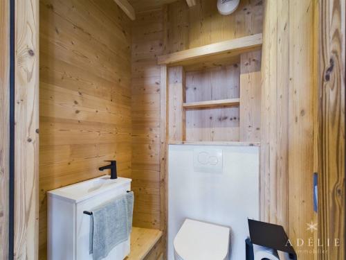 a wooden bathroom with a toilet and a sink at Appartement Montvalezan-La Rosière, 6 pièces, 6 personnes - FR-1-398-662 in Montvalezan