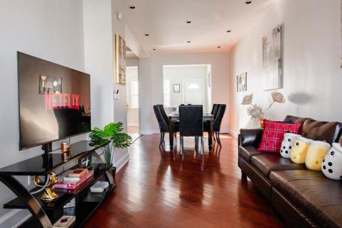 a living room with a couch and a dining room at Comfortable 4 Bedroom Home with City View Near Capitol Hill Washington DC in Washington, D.C.