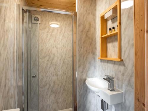 a bathroom with a shower and a sink at School Lodge in Burwarton