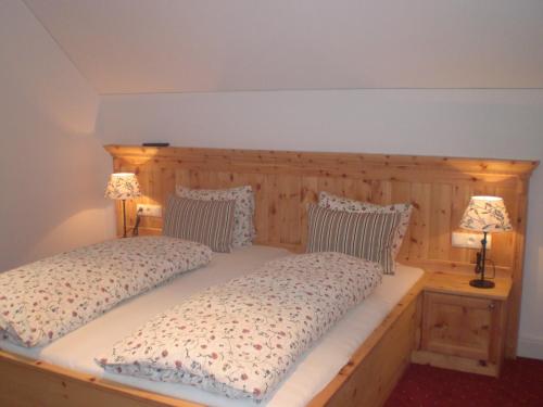 a bedroom with two beds and two lamps on tables at Landhaus Roidergütl in St. Wolfgang