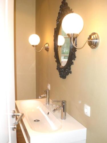 a bathroom with a sink and a mirror at Landhaus Roidergütl in St. Wolfgang