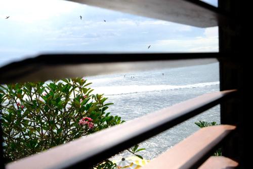a view of the ocean from a window at Bombora Medewi in Pulukan