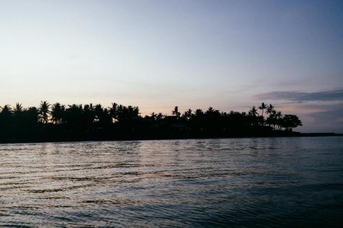 an island in the middle of a body of water at Bombora Medewi in Pulukan