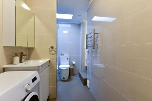 a bathroom with a toilet and a sink at Sunny Apartment in Surry Hills in Sydney