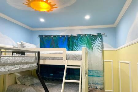 a room with two bunk beds and a ceiling at Rainforest Villa 4 Bedroom PoolSpa Walk2Disneyland in Anaheim
