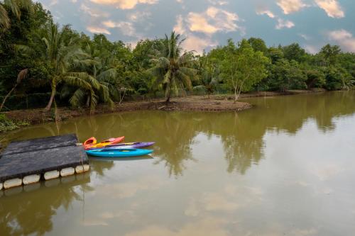 a couple of boats sitting in the water at Putra Sentosa Retreat Camp, Sematan in Sematan